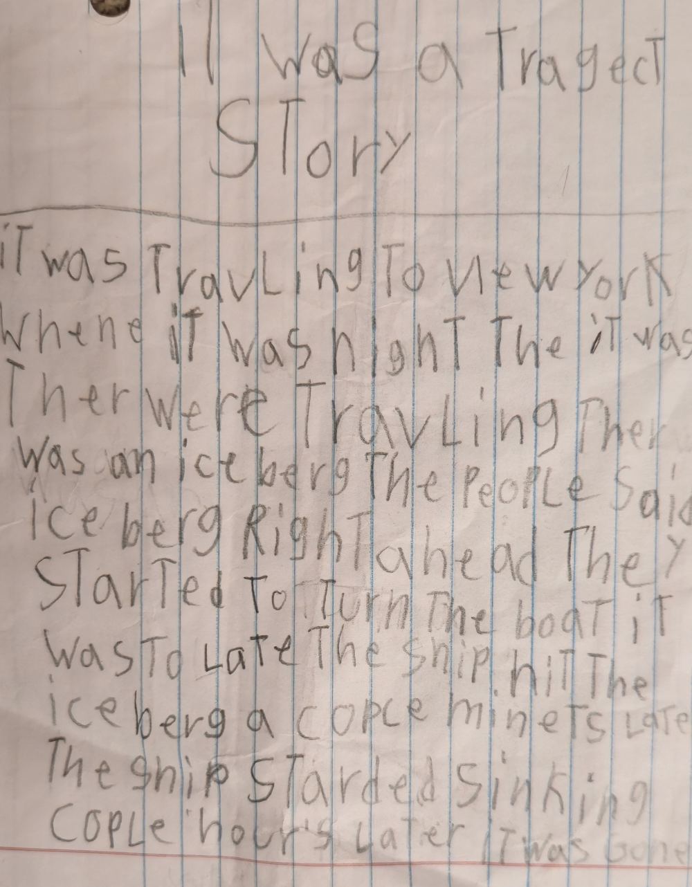 A child's pencil story on ruled paper titled It was a tragect story